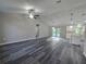 Open-concept living room with modern wood floors, ceiling fan, and recessed lighting at 235 Locust Pass Ln, Ocala, FL 34472