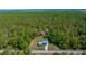 An aerial view of the property and neighborhood, surrounded by verdant green trees at 23737 Nw Mallard Ave, Dunnellon, FL 34431