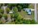 Aerial view of a property with a single-Gathering home, detached garage, and mature trees at 23737 Nw Mallard Ave, Dunnellon, FL 34431