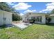 Charming backyard features a patio with table, swing, and well-maintained lawn at 23737 Nw Mallard Ave, Dunnellon, FL 34431