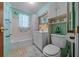 This cozy bathroom is decorated with butterfly wallpaper, a vanity, commode, and shower/tub combo at 23737 Nw Mallard Ave, Dunnellon, FL 34431