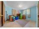 This is a bedroom with blue walls, a neutral carpet, and items being stored in boxes at 23737 Nw Mallard Ave, Dunnellon, FL 34431