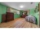 Cozy bedroom with light-green walls, wood-look floors, and ample closet space at 23737 Nw Mallard Ave, Dunnellon, FL 34431