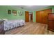 Comfortable bedroom features wood-look floors and a cozy bed with closet space at 23737 Nw Mallard Ave, Dunnellon, FL 34431