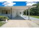 Exterior shot of a covered carport attached to the house and greenery at 23737 Nw Mallard Ave, Dunnellon, FL 34431
