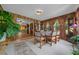 Bright dining room area with wood paneled walls and many windows at 23737 Nw Mallard Ave, Dunnellon, FL 34431
