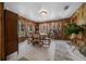 Large dining room area with wood paneled walls and natural lighting at 23737 Nw Mallard Ave, Dunnellon, FL 34431