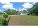 Well-maintained single-Gathering home with a long driveway, detached garage, and expansive front lawn at 23737 Nw Mallard Ave, Dunnellon, FL 34431