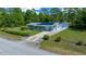 Well-maintained one-story home with mature landscaping, long driveway, and detached single-car garage at 23737 Nw Mallard Ave, Dunnellon, FL 34431