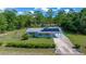 Charming single-story home featuring solar panels, a covered carport, and a well-manicured front yard at 23737 Nw Mallard Ave, Dunnellon, FL 34431