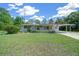 Well-maintained front yard with lush green grass, landscaping and a home view at 23737 Nw Mallard Ave, Dunnellon, FL 34431