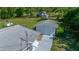 View of detached garage with mature landscaping near main house, visible from the roof at 23737 Nw Mallard Ave, Dunnellon, FL 34431