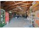 Detached garage interior featuring ample storage, tools, and concrete flooring at 23737 Nw Mallard Ave, Dunnellon, FL 34431