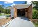 Open detached garage with visible storage, tools, and concrete flooring at 23737 Nw Mallard Ave, Dunnellon, FL 34431