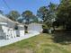 View of a detached single-car garage with painted concrete path to the main house on a sunny day at 23737 Nw Mallard Ave, Dunnellon, FL 34431