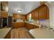Classic kitchen with wood cabinets, modern appliances, and bright countertops creating a warm atmosphere at 23737 Nw Mallard Ave, Dunnellon, FL 34431