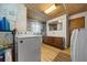 Functional laundry room featuring a washing machine, utility sink and wood look floors at 23737 Nw Mallard Ave, Dunnellon, FL 34431
