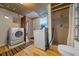 Functional laundry area featuring appliances, updated shower, and utility sink at 23737 Nw Mallard Ave, Dunnellon, FL 34431