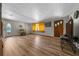 Open living room with laminate floors and a front door with stained glass side panels for added character at 23737 Nw Mallard Ave, Dunnellon, FL 34431