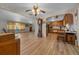 Inviting living room with hardwood floors leading into the kitchen, and an abundance of natural light at 23737 Nw Mallard Ave, Dunnellon, FL 34431