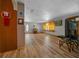 Open living room filled with natural light, wood laminate floors, and a view to the outside at 23737 Nw Mallard Ave, Dunnellon, FL 34431