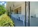 Welcoming covered porch with seating and charming decorative details at 23737 Nw Mallard Ave, Dunnellon, FL 34431