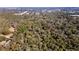 Expansive aerial view of a property, highlighting its secluded location amid a dense forest at 3250 Sw 46Th Ave, Ocala, FL 34474