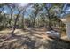 Backyard featuring foliage, the white house, and the propane tank for well water at 3250 Sw 46Th Ave, Ocala, FL 34474