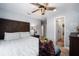 Comfortable bedroom featuring wood flooring, a ceiling fan, and ensuite access at 3250 Sw 46Th Ave, Ocala, FL 34474