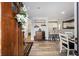 Warm and inviting entryway with a wooden door, leading to the open-concept dining and kitchen area at 3250 Sw 46Th Ave, Ocala, FL 34474