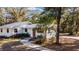Side view of a white home featuring a well-manicured lawn and walkway leading to the entrance at 3250 Sw 46Th Ave, Ocala, FL 34474