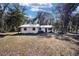 A single-story home is nestled among mature trees, offering a serene and private setting at 3250 Sw 46Th Ave, Ocala, FL 34474