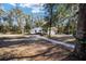 Charming single-story home with a concrete walkway, surrounded by mature trees and a spacious front yard at 3250 Sw 46Th Ave, Ocala, FL 34474