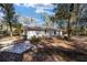 View of the back exterior of the home featuring a concrete driveway and beautiful foliage at 3250 Sw 46Th Ave, Ocala, FL 34474