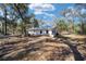View of home's exterior surrounded by trees at 3250 Sw 46Th Ave, Ocala, FL 34474