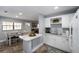 Bright kitchen featuring white cabinetry, modern appliances, and an open dining area at 3250 Sw 46Th Ave, Ocala, FL 34474
