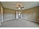 Spacious bedroom featuring plush carpeting, ceiling fan, and neutral paint tones at 36 Locust Radl, Ocala, FL 34472