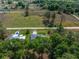 Aerial view of two homes with a expansive grassy field in the background at 3792 Sw 152Nd Ct, Ocala, FL 34481