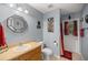 Bathroom featuring light blue walls, framed mirror, and a door to the backyard at 3792 Sw 152Nd Ct, Ocala, FL 34481