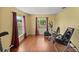 Spacious exercise room with hardwood floors, curtains, and a variety of workout equipment at 3792 Sw 152Nd Ct, Ocala, FL 34481