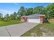 Single-story home with a large driveway and a two-car garage at 3792 Sw 152Nd Ct, Ocala, FL 34481