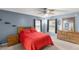 Serene main bedroom with large windows, ceiling fan, and a cozy atmosphere for relaxation at 3792 Sw 152Nd Ct, Ocala, FL 34481