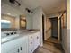 Modern bathroom featuring double vanity with granite countertop and wood-look tile flooring at 4374 Sw Viola Ct, Dunnellon, FL 34431