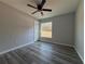 This cozy bedroom features stylish floors, a ceiling fan, and lots of natural light at 4374 Sw Viola Ct, Dunnellon, FL 34431