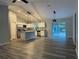 Open-concept living room flows into the kitchen with access to the backyard through sliding doors at 4374 Sw Viola Ct, Dunnellon, FL 34431