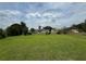 Expansive backyard view showing the grassy lawn, mature trees, and partial fencing at 4513 Nw 30Th Pl, Ocala, FL 34482