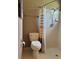 Bathroom with a toilet, tiled shower and shower curtain at 4513 Nw 30Th Pl, Ocala, FL 34482