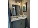 Bathroom with gray vanity, sink, and mirror at 4513 Nw 30Th Pl, Ocala, FL 34482