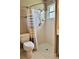 Bathroom with a toilet, tiled shower and shower curtain at 4513 Nw 30Th Pl, Ocala, FL 34482