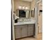 Bathroom featuring a stylish vanity with a light grey cabinet, marine decor and bright vanity lighting at 4513 Nw 30Th Pl, Ocala, FL 34482